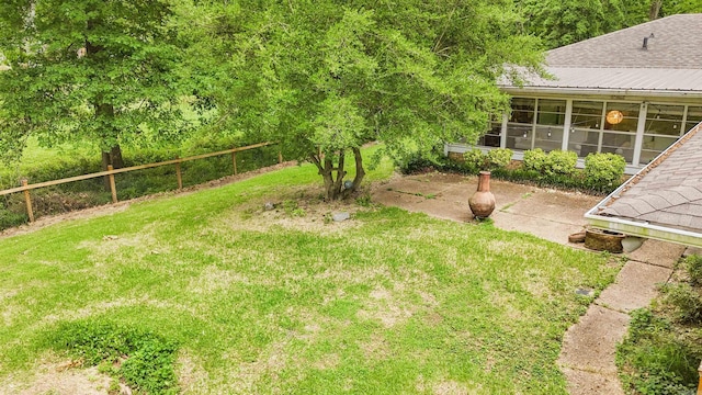 38 Wolfe, Mcgehee, AR 71654 - view of grassy yard featuring a patio area and a sunroom