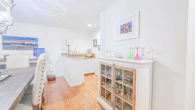 38 Wolfe, Mcgehee, AR 71654 - bar area featuring light wood-style floors, a chandelier, recessed lighting, and baseboards
