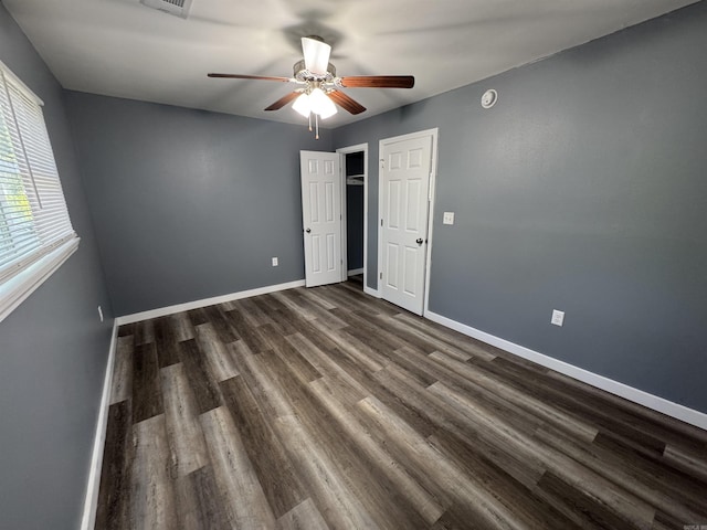 2314 Woodland Bluff Dr, Heber Springs, AR 72543 - unfurnished bedroom with dark wood-type flooring, baseboards, and ceiling fan