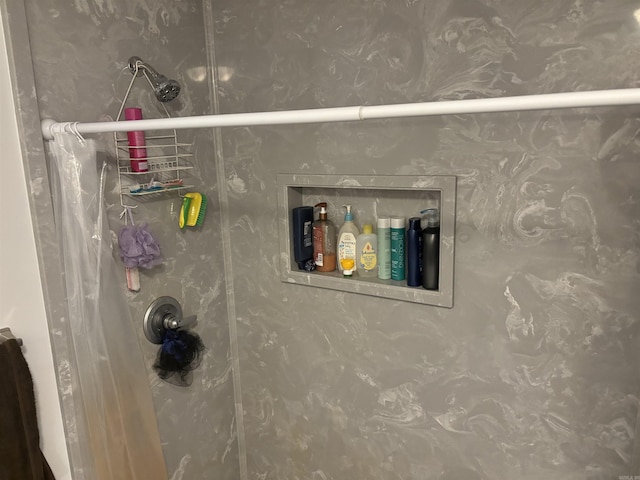 bathroom view of a shower with shower curtain