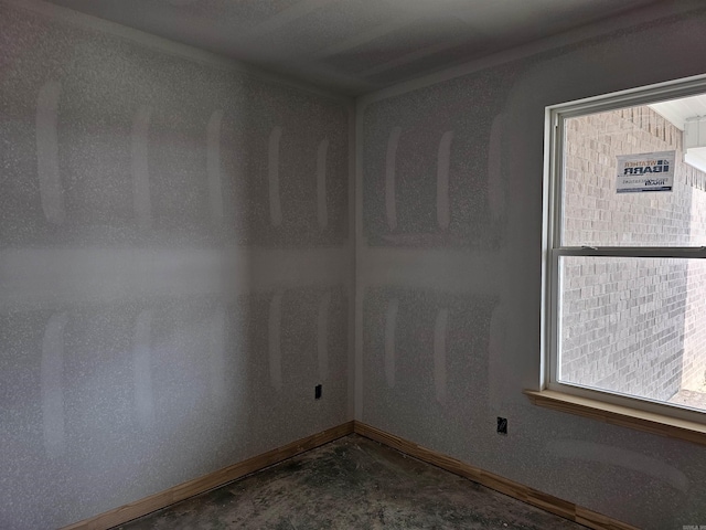 180 Kelton St, Hensley, AR 72065 - empty room featuring concrete flooring, baseboards, and healthy amount of natural light