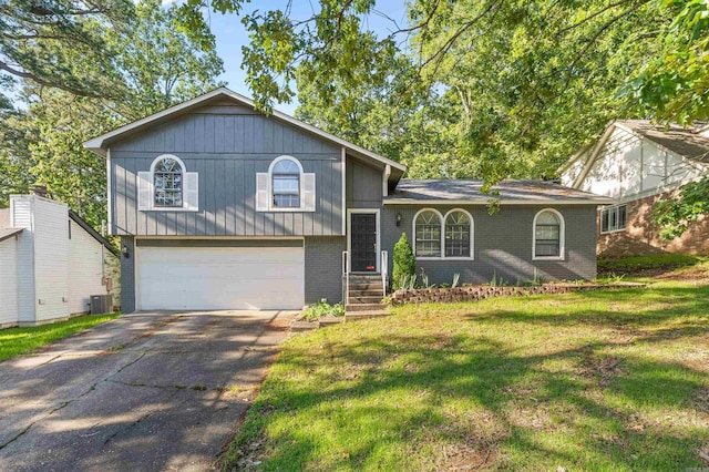 11801 Pleasant Frst, Little Rock, AR 72212 - split level home with an attached garage, brick siding, a front lawn, driveway, and central AC