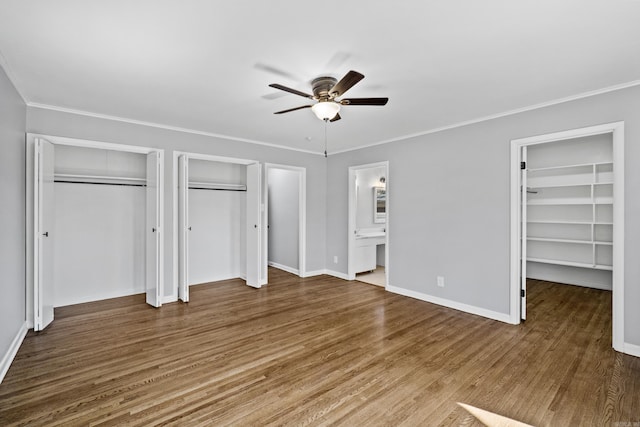 7011 W Markham St, Little Rock, AR 72205 - unfurnished bedroom with wood finished floors, ornamental molding, ensuite bath, baseboards, and a ceiling fan