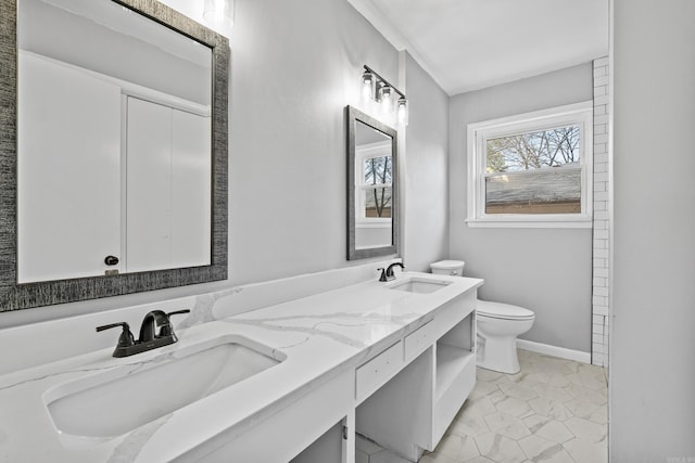 7011 W Markham St, Little Rock, AR 72205 - full bath with toilet, double vanity, and baseboards