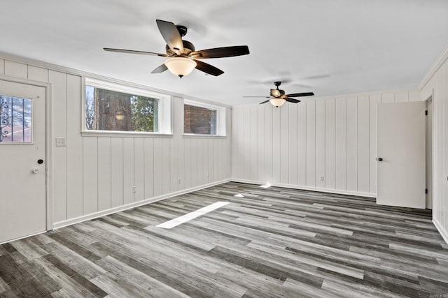 7011 W Markham St, Little Rock, AR 72205 - unfurnished living room with wood finished floors, a ceiling fan, and baseboards
