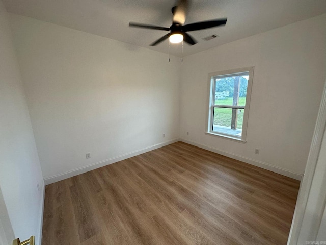 1656 Airport Dr, Mountain View, AR 72560 - empty room featuring wood finished floors, a ceiling fan, and baseboards