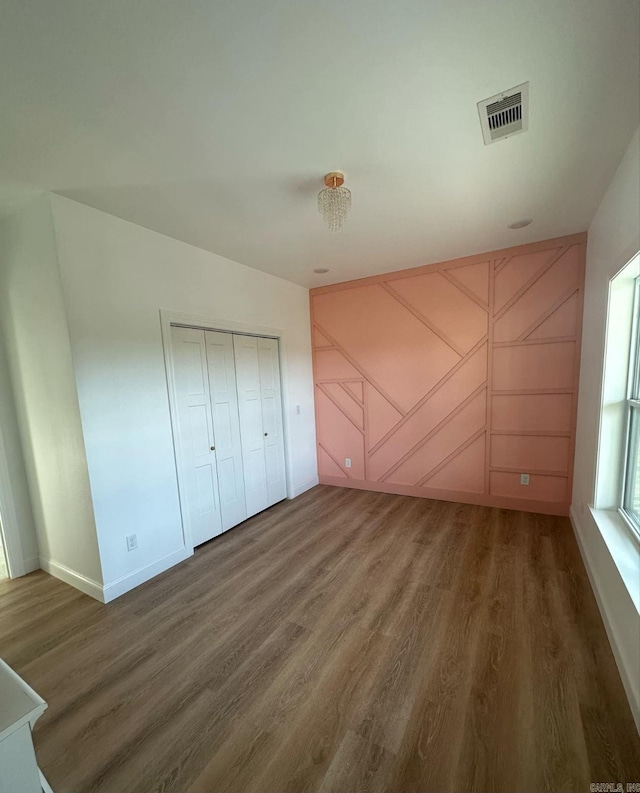 1656 Airport Dr, Mountain View, AR 72560 - unfurnished bedroom with wood finished floors, baseboards, and a closet