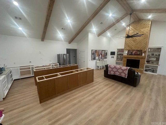 1656 Airport Dr, Mountain View, AR 72560 - living room featuring light wood-style floors, beam ceiling, a fireplace, high vaulted ceiling, and a ceiling fan