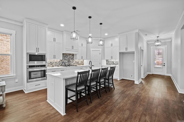 81 Fletcher Ridge Dr, Little Rock, AR 72223 - kitchen with stainless steel oven, light countertops, built in microwave, white cabinetry, and recessed lighting