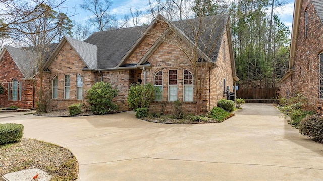 4405 Boardwalk, Benton, AR 72019 - view of front of property featuring concrete driveway, brick siding, and a shingled roof