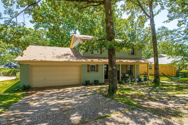 2006 Gunpowder Rd, Little Rock, AR 72227 - view of front of home featuring brick siding, gravel driveway, an attached garage, and a porch