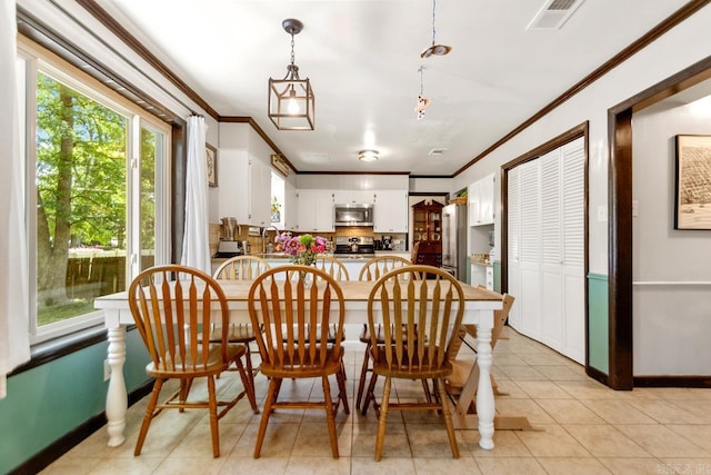 2006 Gunpowder Rd, Little Rock, AR 72227 - dining area featuring crown molding, light tile patterned floors, and baseboards