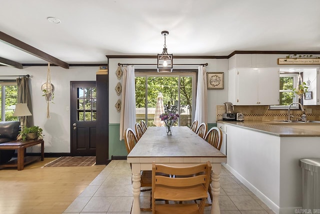 2006 Gunpowder Rd, Little Rock, AR 72227 - dining space with healthy amount of natural light, baseboards, beam ceiling, and light tile patterned floors