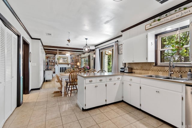 2006 Gunpowder Rd, Little Rock, AR 72227 - kitchen with a sink, crown molding, light countertops, tasteful backsplash, and white cabinetry