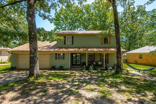 2006 Gunpowder Rd, Little Rock, AR 72227 - traditional-style house with a porch, a garage, brick siding, and driveway