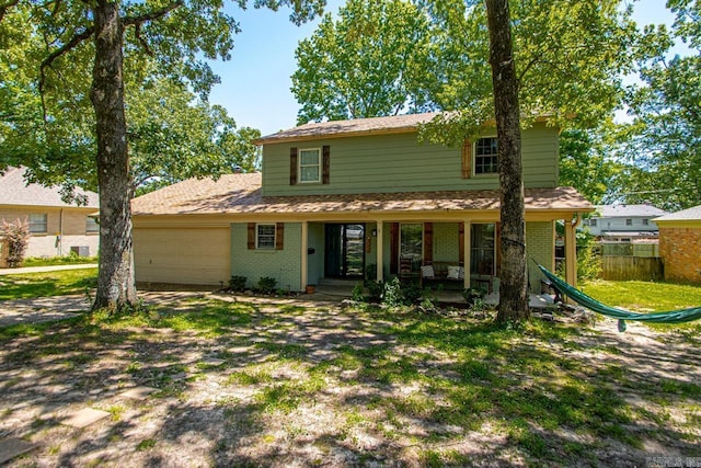 2006 Gunpowder Rd, Little Rock, AR 72227 - traditional-style home with brick siding, a garage, covered porch, and driveway