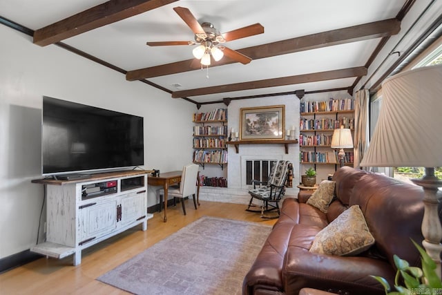 2006 Gunpowder Rd, Little Rock, AR 72227 - living room with beamed ceiling, ceiling fan, wood finished floors, a brick fireplace, and baseboards