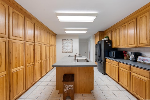 50 Merritt Trl, Greenbrier, AR 72058 - kitchen with black appliances, a sink, light tile patterned floors, and an island with sink