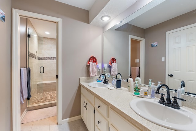 1 Forest Brook Ct, Little Rock, AR 72211 - full bathroom featuring double vanity, a stall shower, tile patterned floors, and baseboards