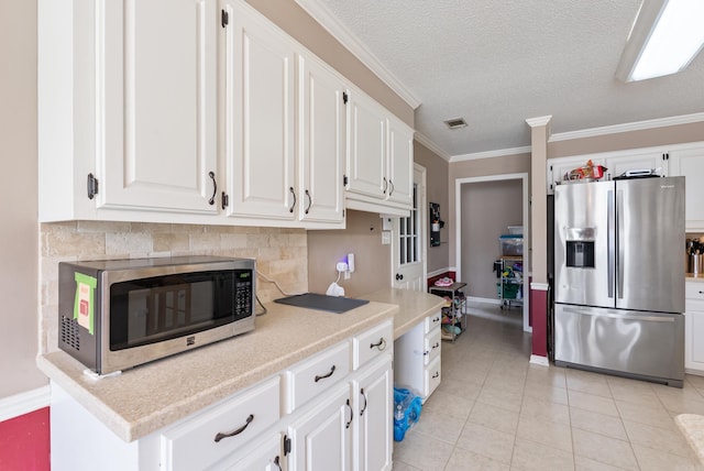 1 Forest Brook Ct, Little Rock, AR 72211 - kitchen featuring stainless steel appliances, white cabinetry, light countertops, light tile patterned flooring, and baseboards