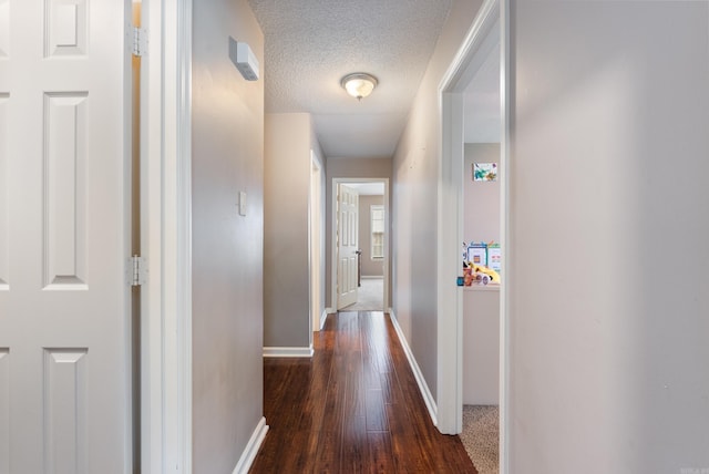 1 Forest Brook Ct, Little Rock, AR 72211 - hall featuring baseboards, dark wood-type flooring, and a textured ceiling