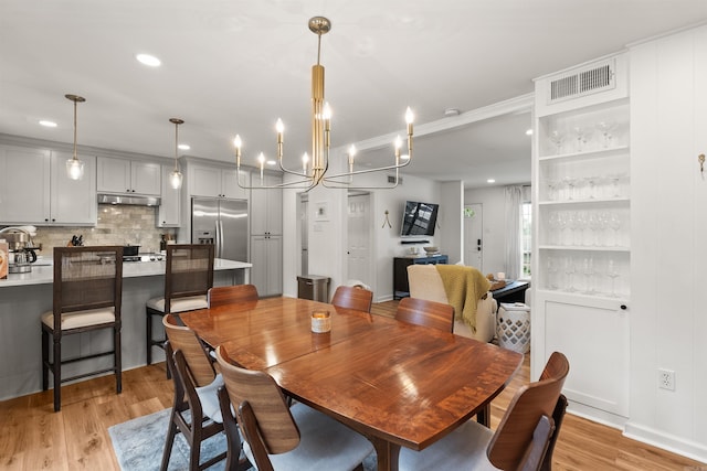 8010 Iowa Dr, Little Rock, AR 72227 - dining space featuring light wood-style floors, a chandelier, and recessed lighting