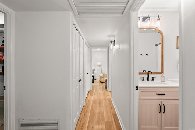 8010 Iowa Dr, Little Rock, AR 72227 - hallway featuring a sink and light wood finished floors