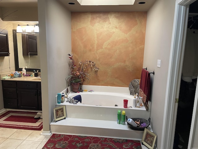 284 Grant 167077, Sheridan, AR 72150 - bathroom featuring vanity, a whirlpool tub, tile patterned flooring, a skylight, and baseboards