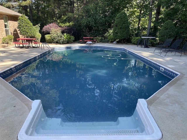 284 Grant 167077, Sheridan, AR 72150 - outdoor pool with a patio and view of scattered trees