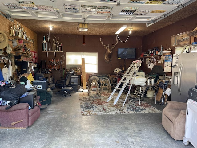 284 Grant 167077, Sheridan, AR 72150 - garage featuring stainless steel fridge with ice dispenser and a workshop area