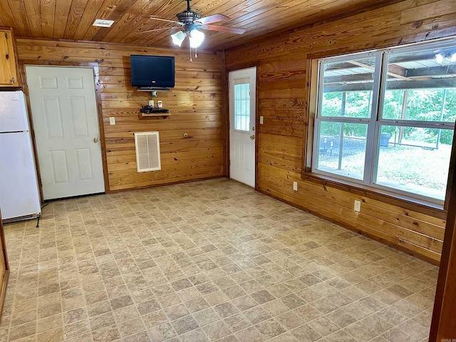 540 Polk Rd 78, Mena, AR 71953 - unfurnished living room with wooden ceiling, wooden walls, a ceiling fan, and brick patterned floors