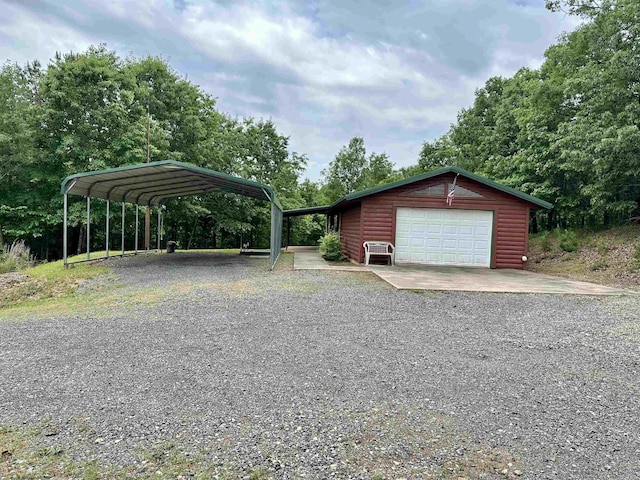 540 Polk Rd 78, Mena, AR 71953 - detached garage with gravel driveway and a carport