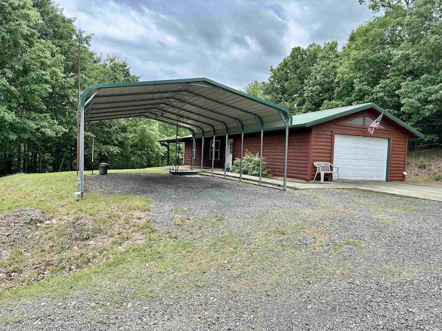 540 Polk Rd 78, Mena, AR 71953 - view of front of property featuring log veneer siding, a detached garage, and driveway