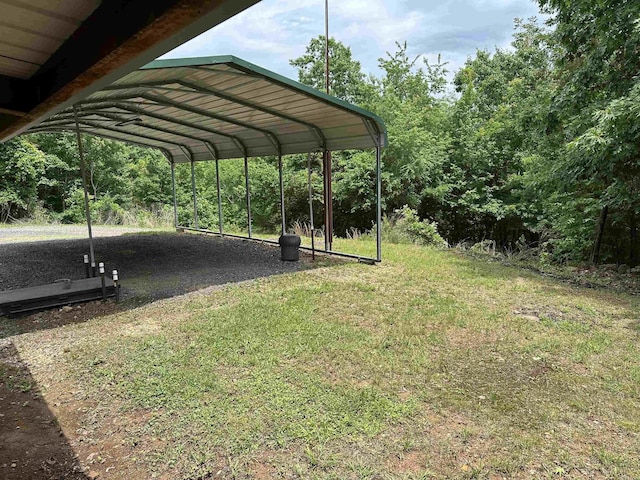 540 Polk Rd 78, Mena, AR 71953 - view of green lawn with a detached carport