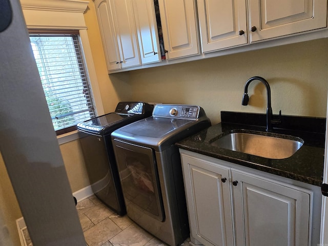 23 Whispering Dr, Alexander, AR 72002 - washroom featuring washer and clothes dryer, cabinet space, light tile patterned flooring, and baseboards