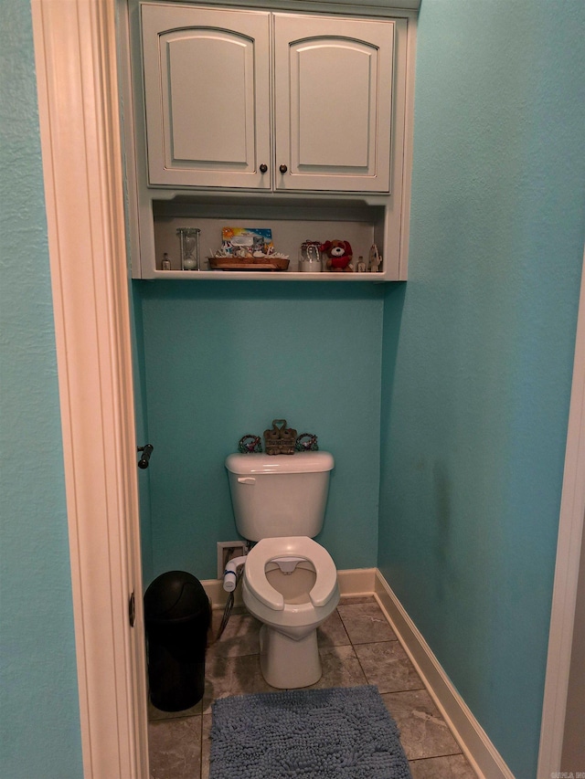 23 Whispering Dr, Alexander, AR 72002 - bathroom featuring toilet, baseboards, and tile patterned flooring