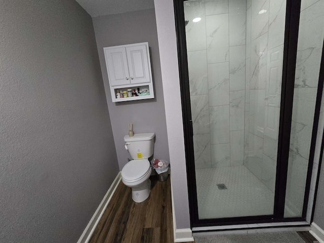 23 Whispering Dr, Alexander, AR 72002 - bathroom with wood finished floors, toilet, a stall shower, and baseboards