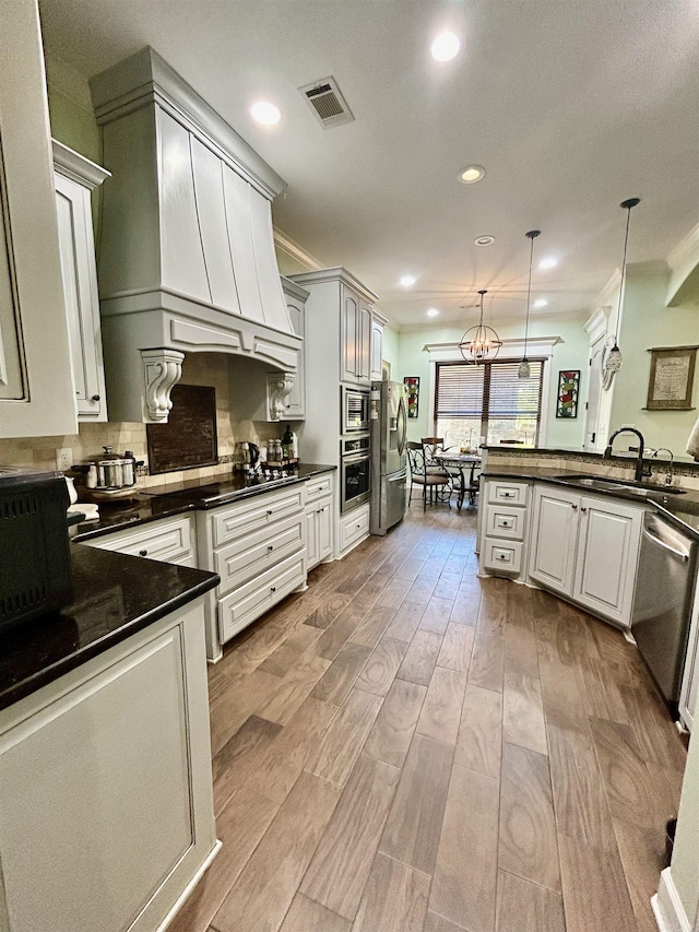 23 Whispering Dr, Alexander, AR 72002 - kitchen with a sink, appliances with stainless steel finishes, dark countertops, wood finished floors, and recessed lighting