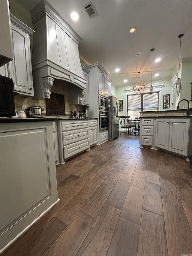 23 Whispering Dr, Alexander, AR 72002 - kitchen with stainless steel appliances, dark countertops, dark wood-style floors, recessed lighting, and backsplash