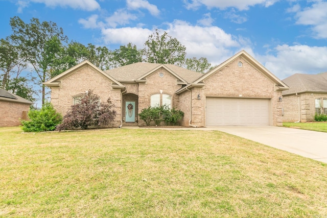 43 Earnhardt Cir, Cabot, AR 72023 - view of front of property with concrete driveway, an attached garage, brick siding, and a front yard
