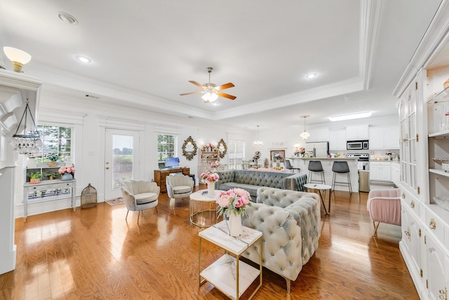 43 Earnhardt Cir, Cabot, AR 72023 - living room featuring a tray ceiling, ceiling fan, light wood finished floors, crown molding, and recessed lighting