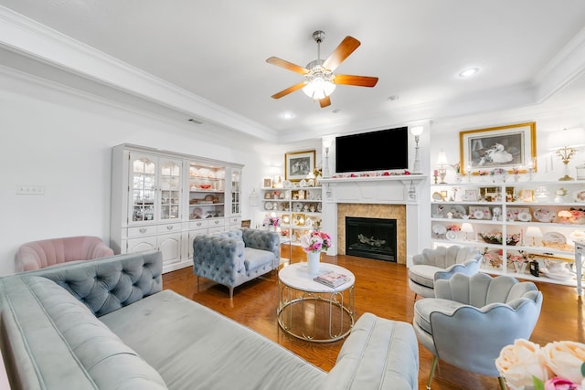 43 Earnhardt Cir, Cabot, AR 72023 - living area with a ceiling fan, wood finished floors, crown molding, a tile fireplace, and a tray ceiling