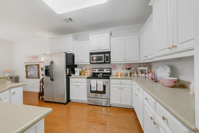 43 Earnhardt Cir, Cabot, AR 72023 - kitchen with stainless steel appliances, white cabinets, light countertops, and ornamental molding