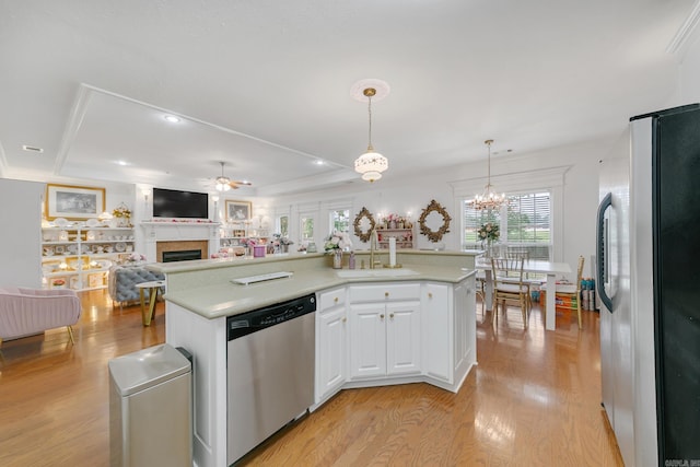 43 Earnhardt Cir, Cabot, AR 72023 - kitchen featuring stainless steel appliances, a sink, a fireplace, light countertops, and recessed lighting