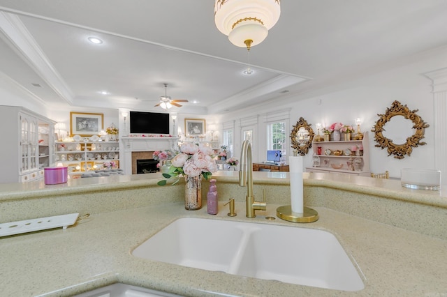 43 Earnhardt Cir, Cabot, AR 72023 - kitchen with a sink, a fireplace, recessed lighting, crown molding, and a raised ceiling