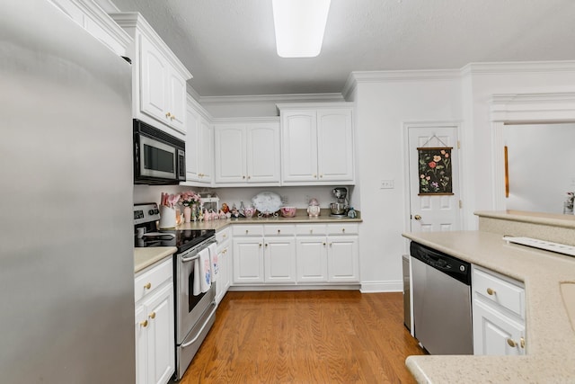 43 Earnhardt Cir, Cabot, AR 72023 - kitchen with appliances with stainless steel finishes, light wood-style flooring, light countertops, white cabinetry, and crown molding