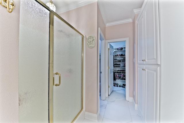 43 Earnhardt Cir, Cabot, AR 72023 - full bathroom with crown molding, a shower stall, baseboards, a walk in closet, and marble look tile flooring