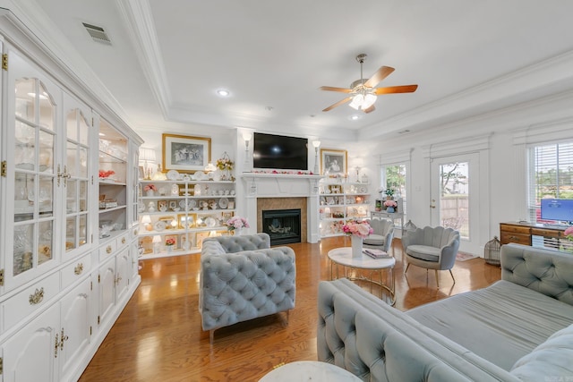 43 Earnhardt Cir, Cabot, AR 72023 - living room with a tray ceiling, a ceiling fan, crown molding, plenty of natural light, and wood finished floors