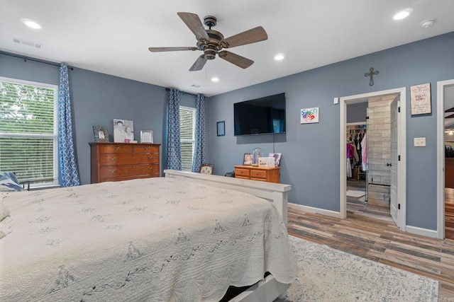 10820 W Sardis Rd, Bauxite, AR 72011 - bedroom featuring a spacious closet, wood finished floors, recessed lighting, baseboards, and ceiling fan
