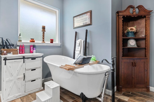 10820 W Sardis Rd, Bauxite, AR 72011 - full bath featuring wood finished floors, a soaking tub, and baseboards